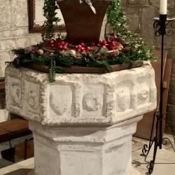 The Font, seen here decorated for Christmas, dates to the mid-C14th.
